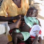 FILE PHOTO: A baby being checked for pneumonia in a local clinic.
