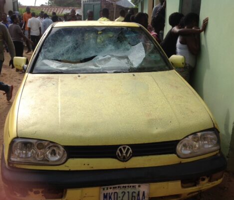 The smashed vehicle in front of the deceased’s apartment. PHOTO BY: Hope Abbah Emmanuel