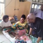 Chief Bode George with one of the victims of Ita-Faaji building collapse during a visit to Lagos Island General Hospital on Wednesday.