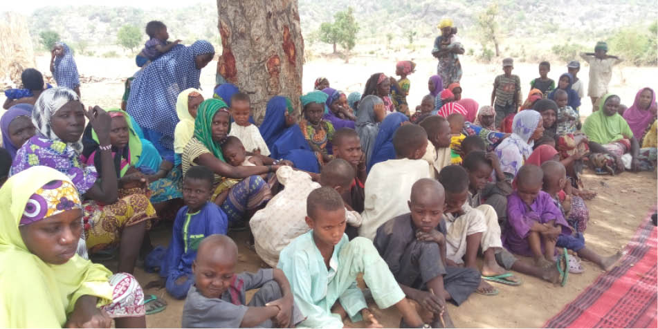 Women and children under a tree at Runde-Bin IDPs settlement
