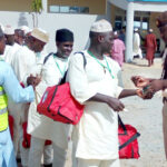 Immigration officers screen the first batch of pilgrims in Katsina State yesterday
