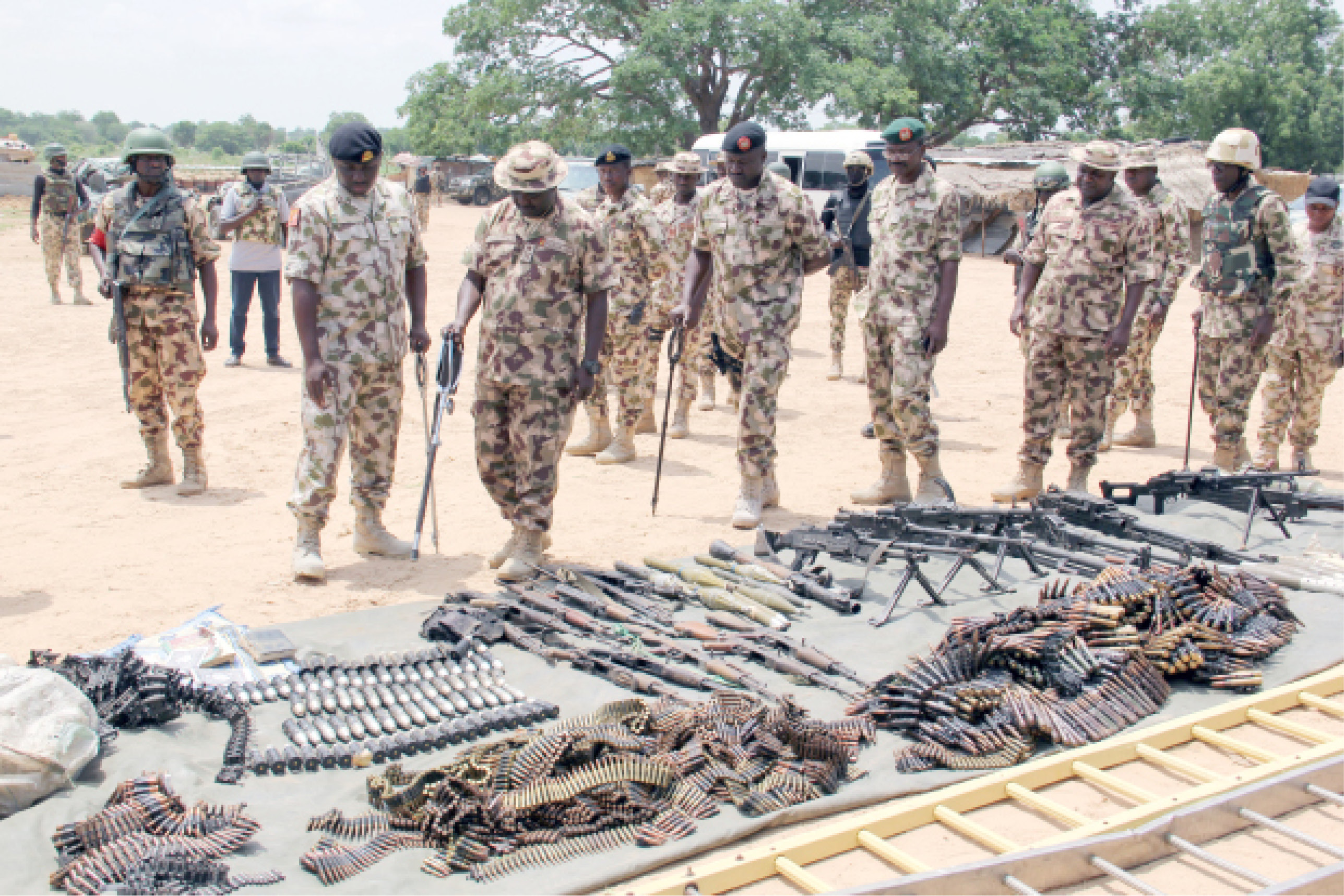 Military commanders inspect arms and ammunitions recovered from Boko Haram members on display at the headquarters of the 120th Battalion in Goniri, Yobe State on Monday