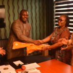 The Deputy Governor of Imo State, Engr. Gerald Irona (L) receiving a Star Times Decoder from the Head of station, NTA Channel 12 Owerri, Mrs. Franca Akinneye during the visit.