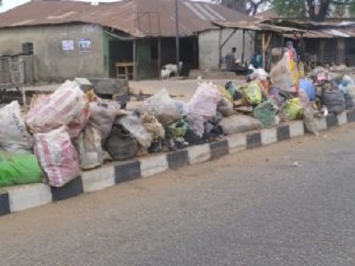 Heaps of refuse deposited at the road median along Emir road in Ilorin, Kwara state on Monday Dec 2, 2019.