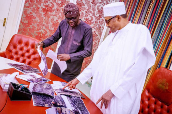 Lagos State Governor, Mr. Babajide Sanwo-Olu (left) briefing President Muhammadu Buhari on the Abule Ado-Soba explosion during a meeting at the Presidential Villa, Abuja yesterday