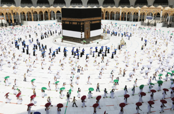 Pilgrims hold coloured umbrellas along matching coloured rings separating them as part of measures to contain the spread of coronavirus while circumambulating around the Kaaba, at the centre of the Grand Mosque in the holy city of Mecca yesterday, at the start of the annual Muslim Hajj pilgrimage. (left) Male pilgrims praying inside the Grand Mosque