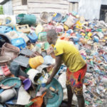 A young 'waste to wealth' entrepreneur engaged in waste collection in Yenagoa, Bayelsa State