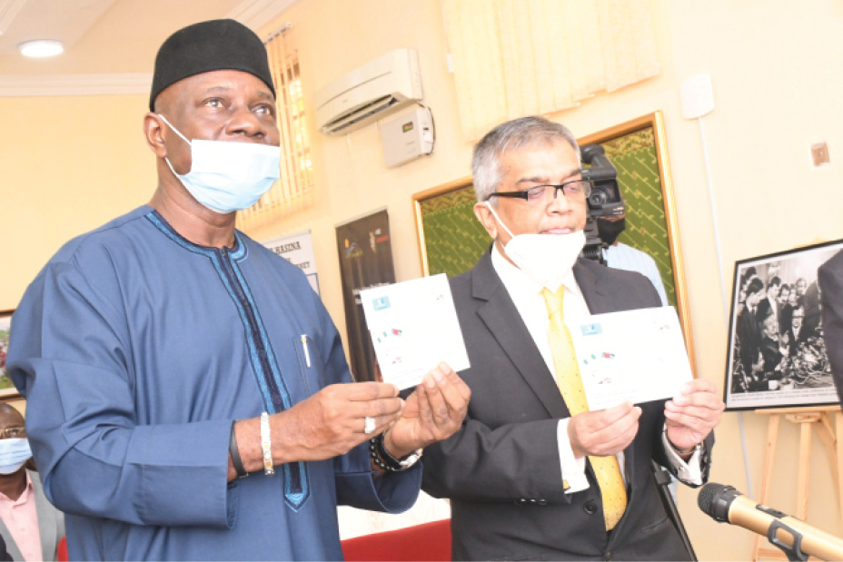 Postmaster- General of the Federation, Dr. Ismail Adebayo Adewusi (left) with the Bangladesh High Commissioner to Nigeria, Shameen Ahsan, display the first cover of the Commemorative Stamp in honour of the Father of Bangladesh Nation, Sheikh Mujibur Rahman, in Abuja