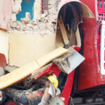 Victims trapped under the rubbles of a building after a truck crashed into the place at Madalla in Niger State on Saturday. Both victims were later rescued Photo: Adam Umar