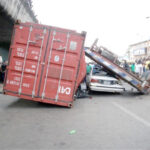 Scene of a container truck accident where the truck crushed a sedan. Scenes like this are increasingly frequent in Lagos
