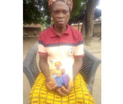 Rose Abah holds a photo taken with her daughter when she was alive