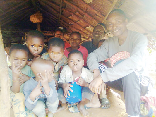 Some of Dorathy's children in her thatched roof kitchen