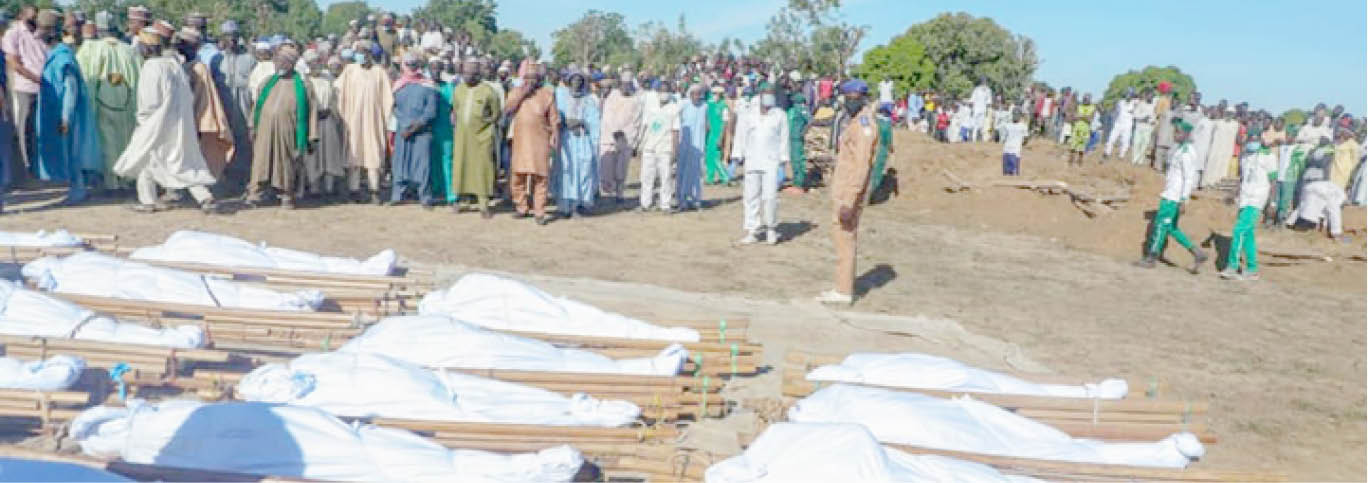Residents glance at the bodies of some of the 43 farmers slaughtered by Boko Haram members on Saturday, before their funeral prayer at Zabarmari in Jere Local Government Area of Borno State yesterday