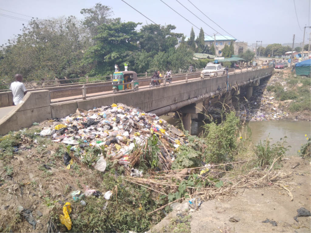 Refuse overwhelms bridge, poses environmental, health threats In Kubwa