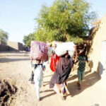 Villagers fleeing Garin Mallam after an attack by suspected herders