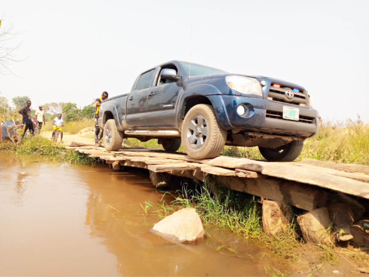 A pickup van crosses a wooden bridge which link Nanda-Panadagi communities in Abaji Area Council.