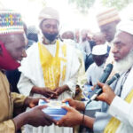 Dr Ahmad Gumi presenting religious books to a Fulani leader in Jere town