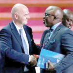 Newly elected member of the FIFA Executive Council, Amaju Pinnick (r) in a warm handshake with FIFA president Gianni Infantino