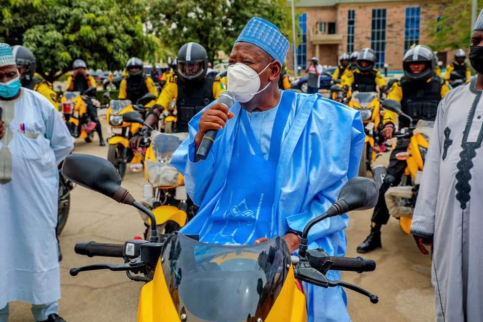 PHOTOS: Ganduje rides power bike in ‘Agbada’