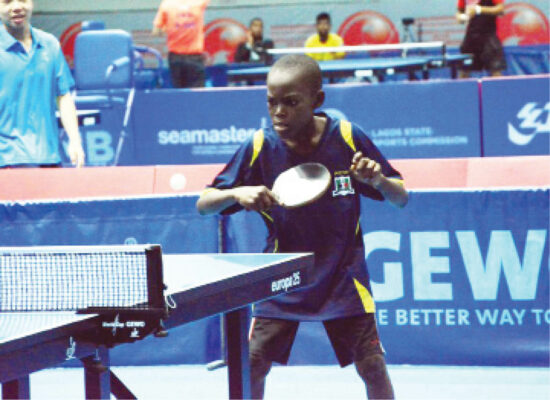 Young Musa Mustapha returns a serve during a match
