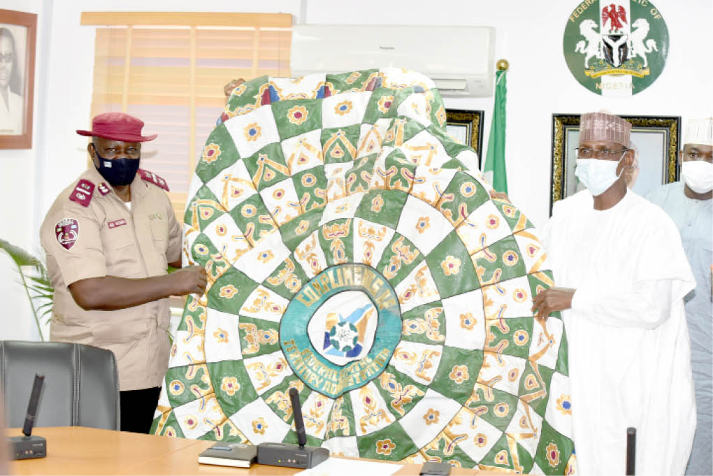 From left: Out-going FCT FRSC SEctor Commander, Mr Gora Wobin, receiving a gift from the FCT Minister Malam Muhammad Musa Bello during the former's farewell visit to the Minister in Abuja at weekend