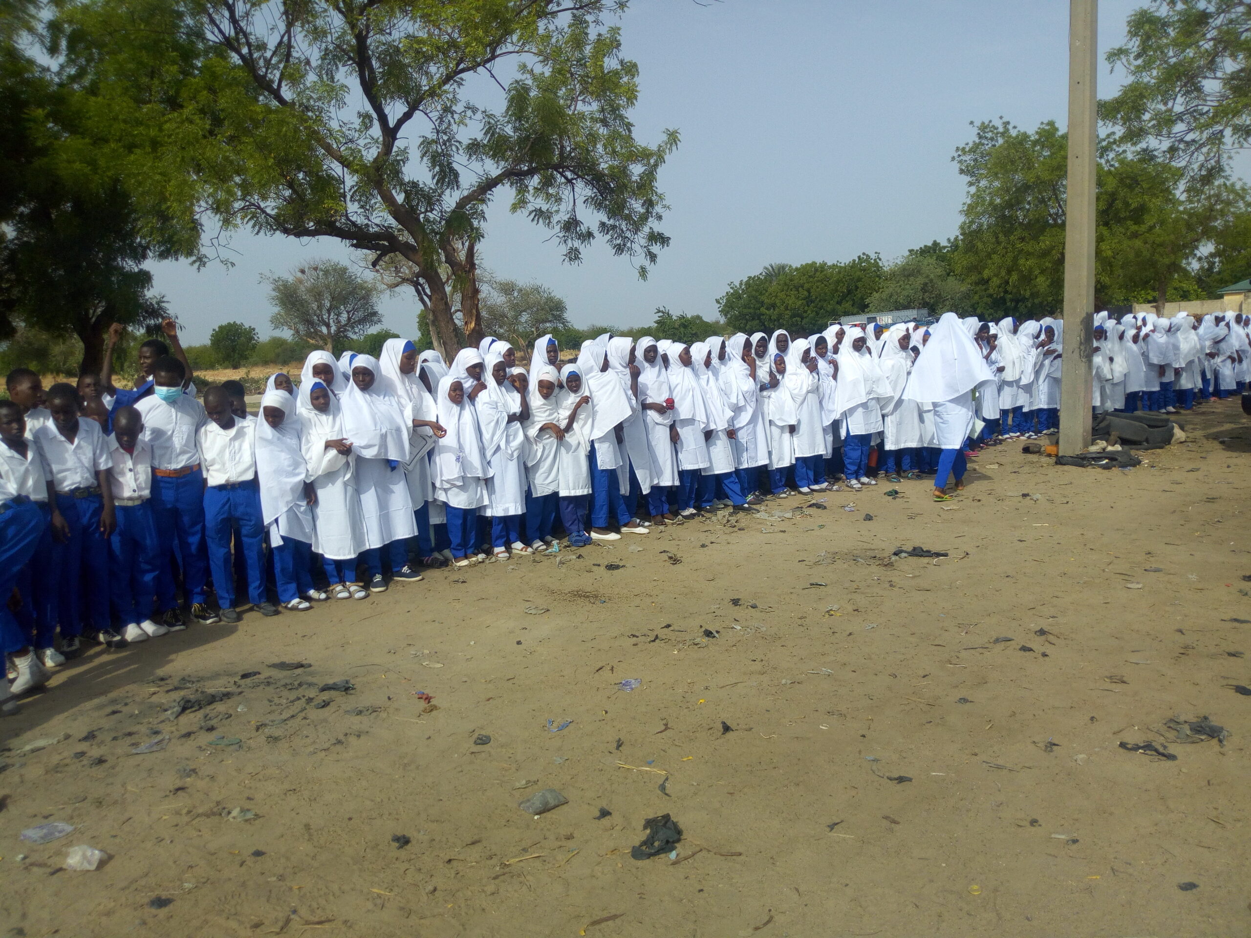 PHOTOS: Secondary School Students awaiting the arrival of Buhari