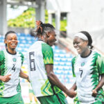 Super Falcons players celebrate after scoring a goal
