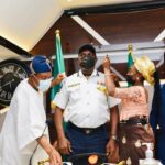 L-R. Minister of Interior Ogbeni Rauf Aregbesola decorating the newly promoted DGC and Acting CG, FFS, Samson Peremobowei Karebo, middle being assisted by his wife, Mrs Karebo, at the CDCFIB conference room in Abuja
