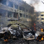 A car burns inside the yard of a hospital in Mariupol, southern Ukraine