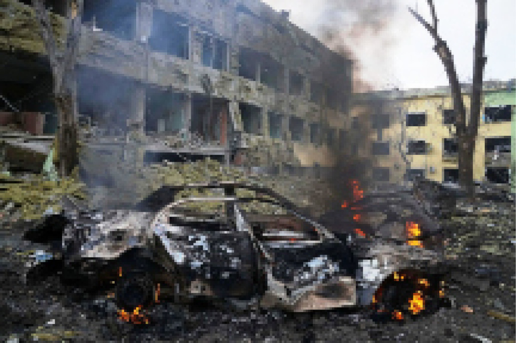 A car burns inside the yard of a hospital in Mariupol, southern Ukraine