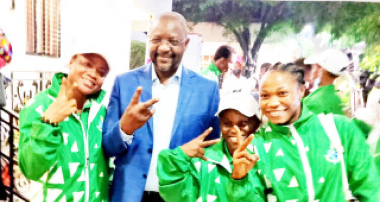 Minister of Sports, Sunday Dare, poses for photograph with some of the Team Nigeria athletes
