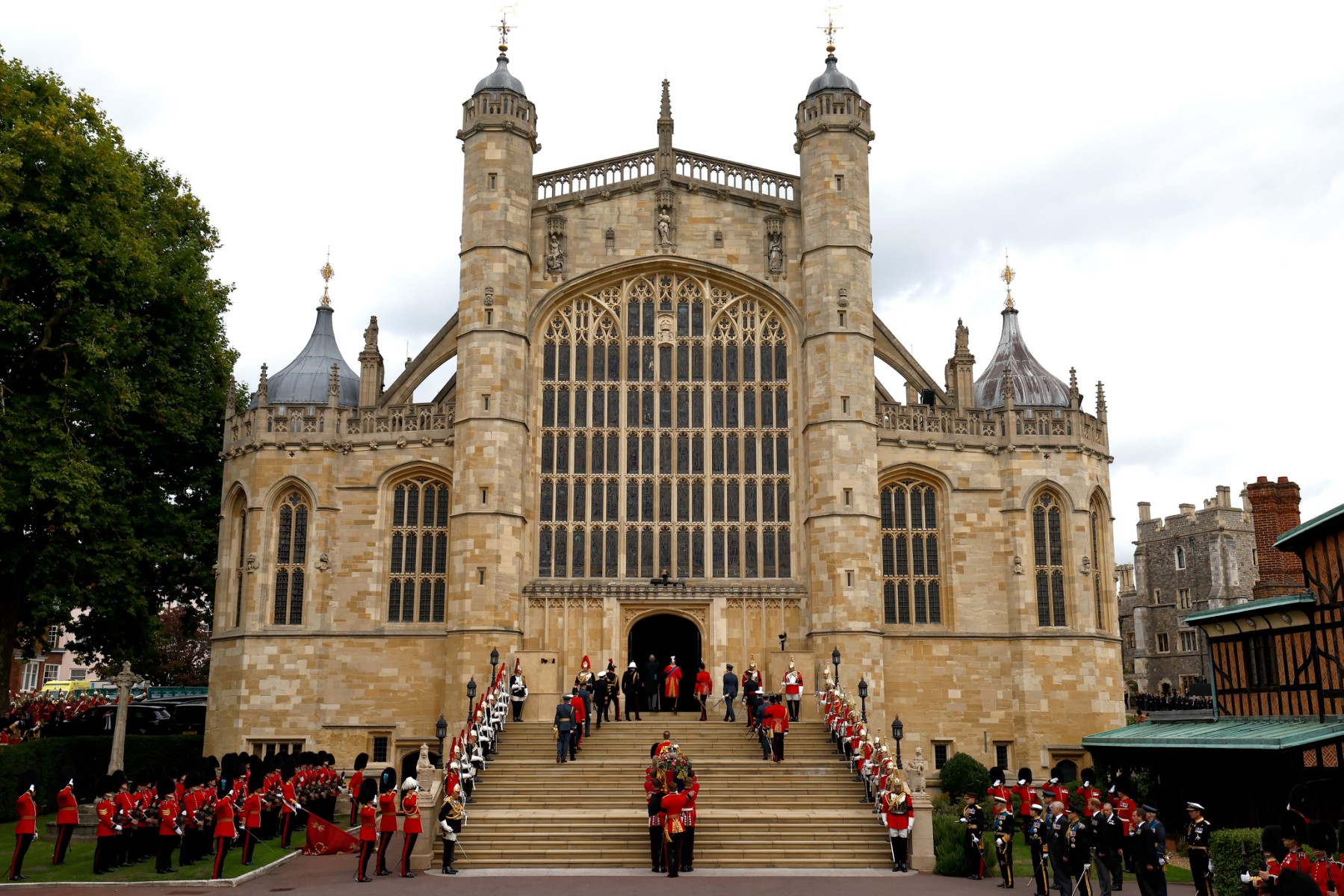 Pall bearers carry the coffin of Queen Elizabeth II with the Imperial State Crown resting on top into St. George's Chapel at Windsor Castle on September 19, 2022 in Windsor, west of London, after making its final journey to Windsor Castle after the State Funeral Service.