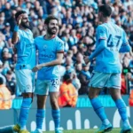 Manchester City players celebrate with Riyad Mahrez after scoring the third goal