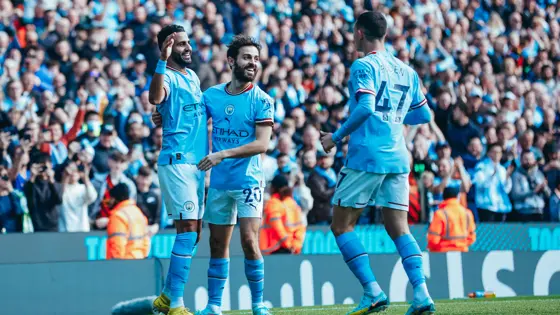 Manchester City players celebrate with Riyad Mahrez after scoring the third goal