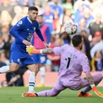 Chelsea's Christian Pulisic dinks the ball over Jose Sa