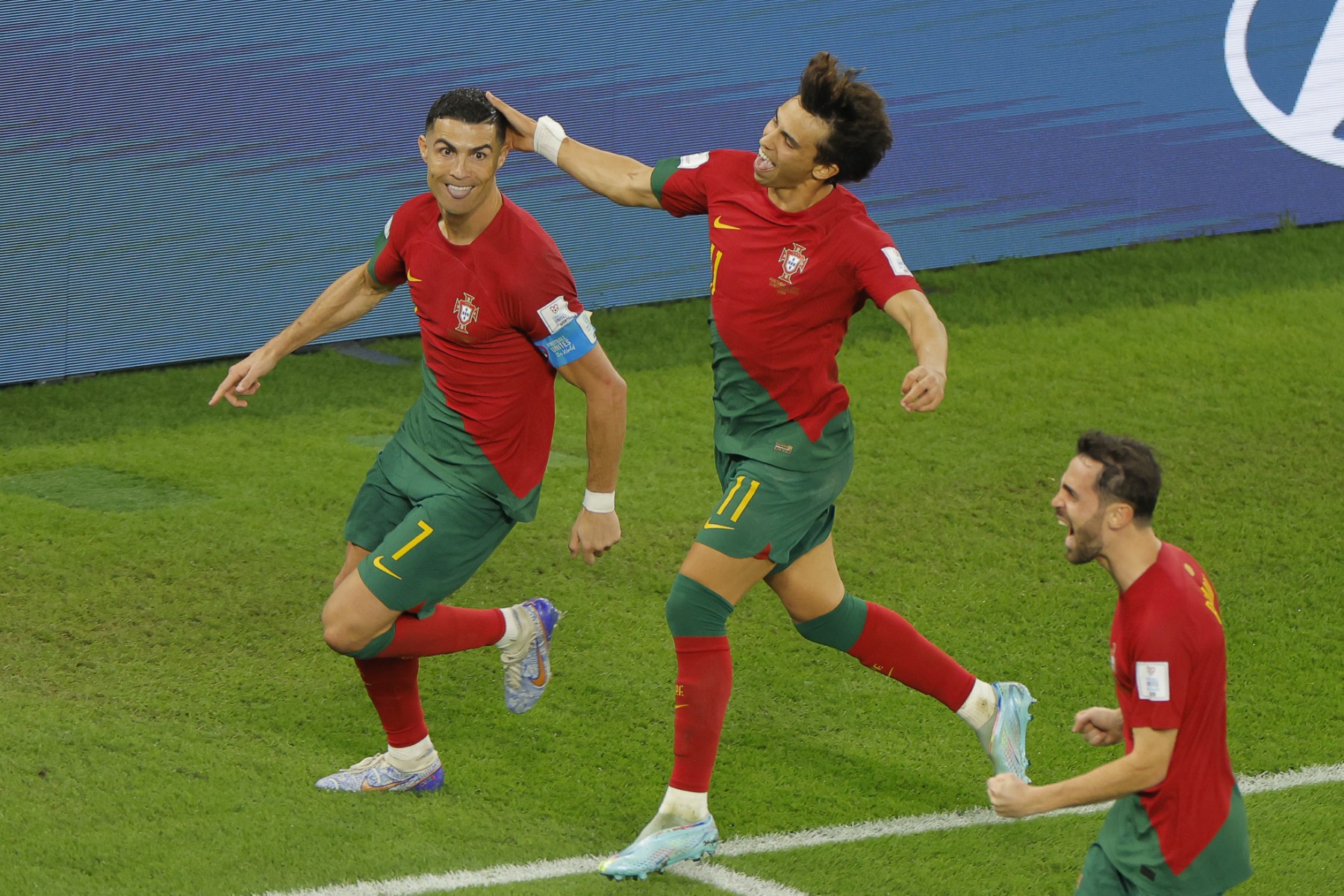 Portugal's forward, Cristiano Ronaldo, celebrates with Portugal's forward #11 Joao Felix and Portugal's midfielder #10 Bernardo Silva after scoring his team's first goal from the penalty spot during the Qatar 2022 World Cup Group H football match between Portugal and Ghana at Stadium 974 in Doha on November 24, 2022. (Photo by Odd ANDERSEN / AFP)