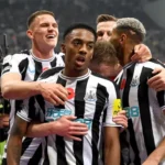 Newcastle players celebrate with Joe Willock after his goal against Chelsea