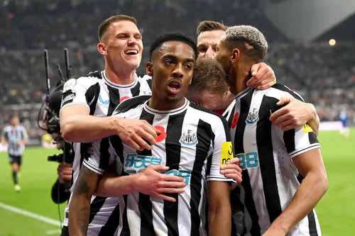 Newcastle players celebrate with Joe Willock after his goal against Chelsea