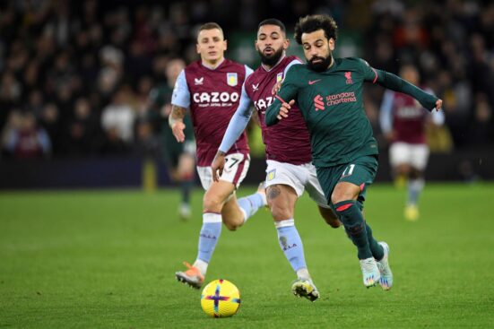 Liverpool's Egyptian striker Mohamed Salah (R) runs with the ball during the English Premier League football match between Aston Villa and Liverpool at Villa Park