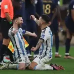 Lionel Messi celebrates Argentina's victory against France with a teammate