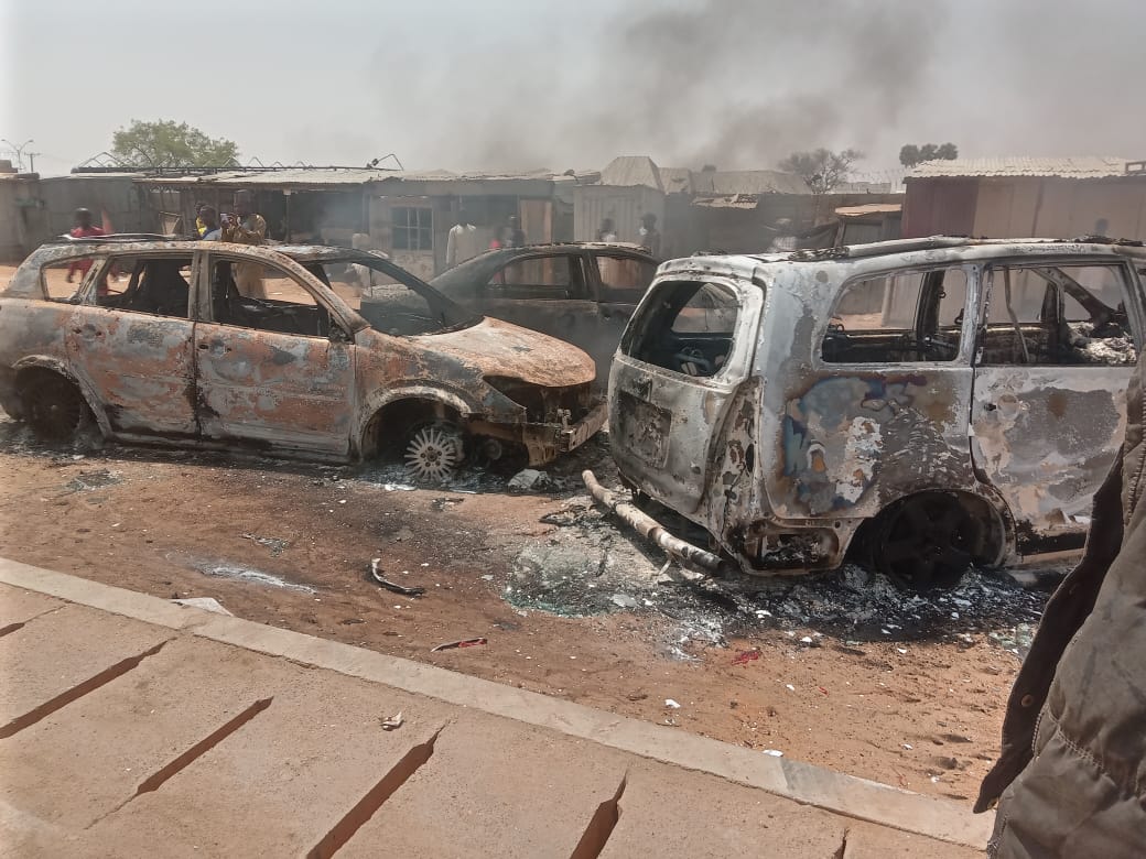 PHOTOS: Thugs burn vehicles, block road as Kwankwaso campaigns in Kano