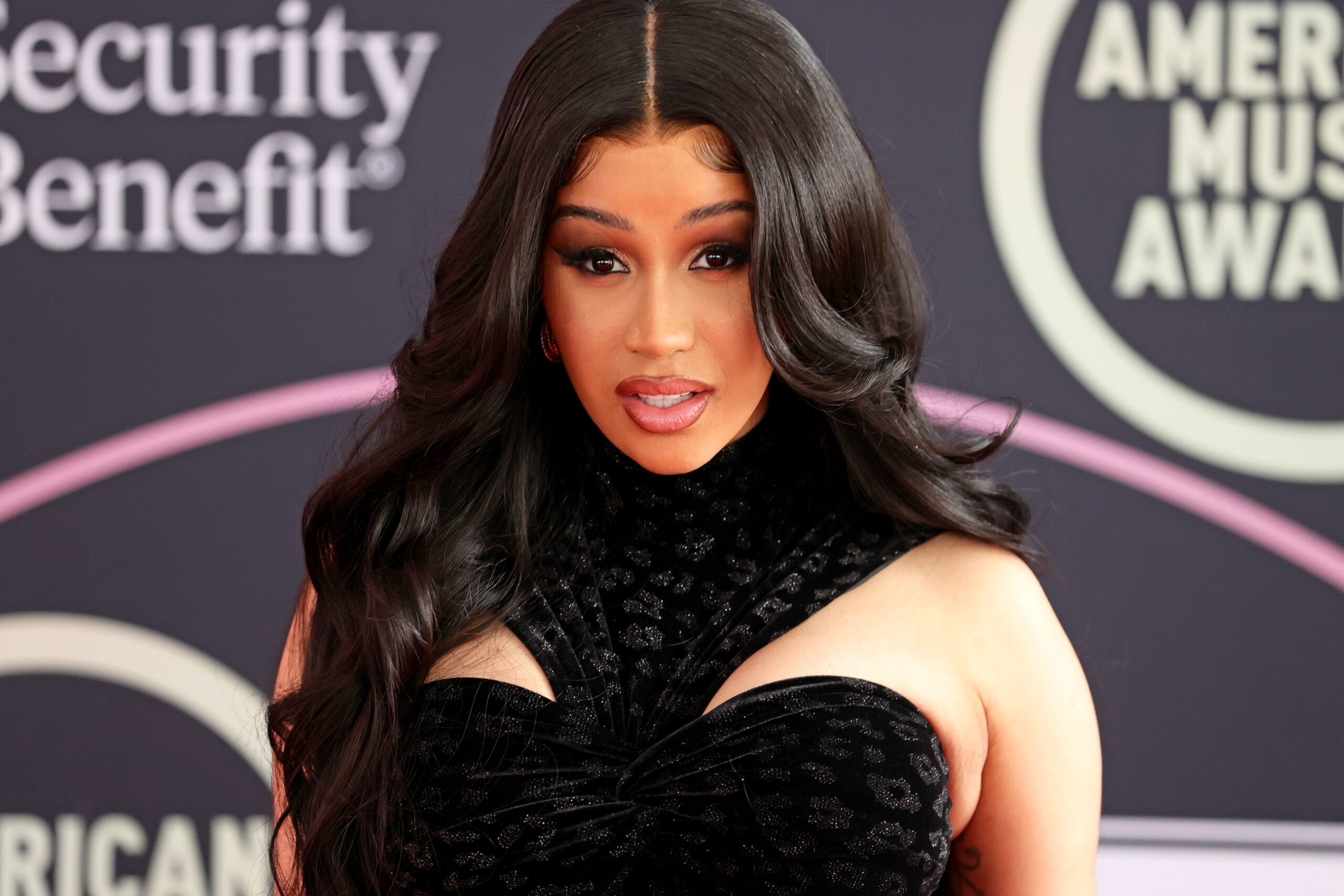 Cardi B throws microphone at concertgoer for tossing drink a