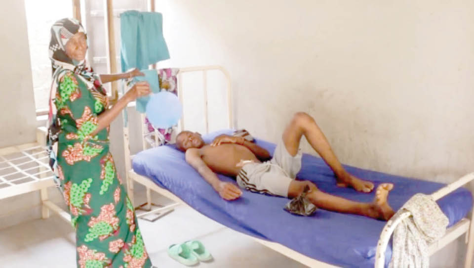 a patients at a hospital in taraba being fanned by a relative