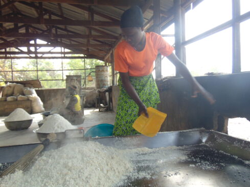 a young lady fries gari