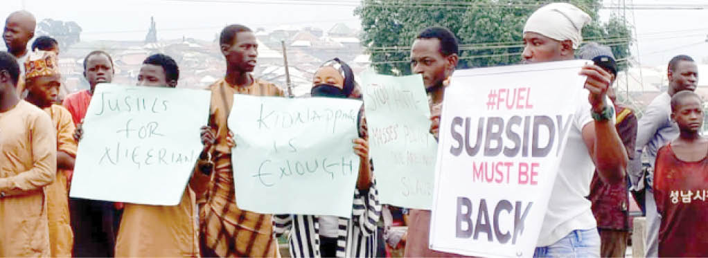 a minor protest by a few people waving placards with various inscriptions on abuja kaduna express way in suleja yesterday