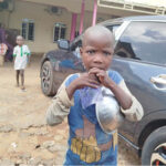 a minor beggar in front of a restaurant