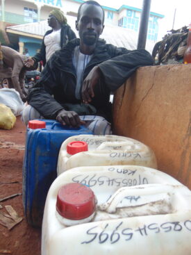 hamza zuma and his jerry cans of honey, sourced from cameroon