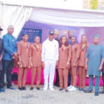 the sports minister, john enoh, flanked by team nigeria wrestlers during the hosting organised by the comptroller general of the nigeria customs service, bashir adewale adeniyi