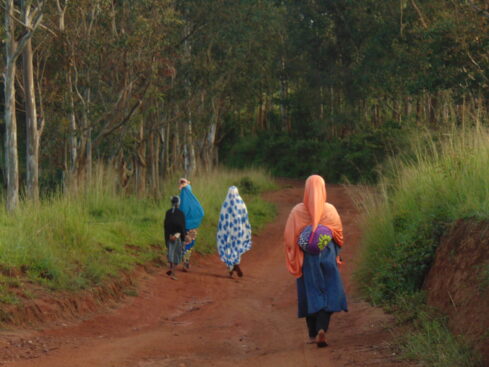 women walk along a country road