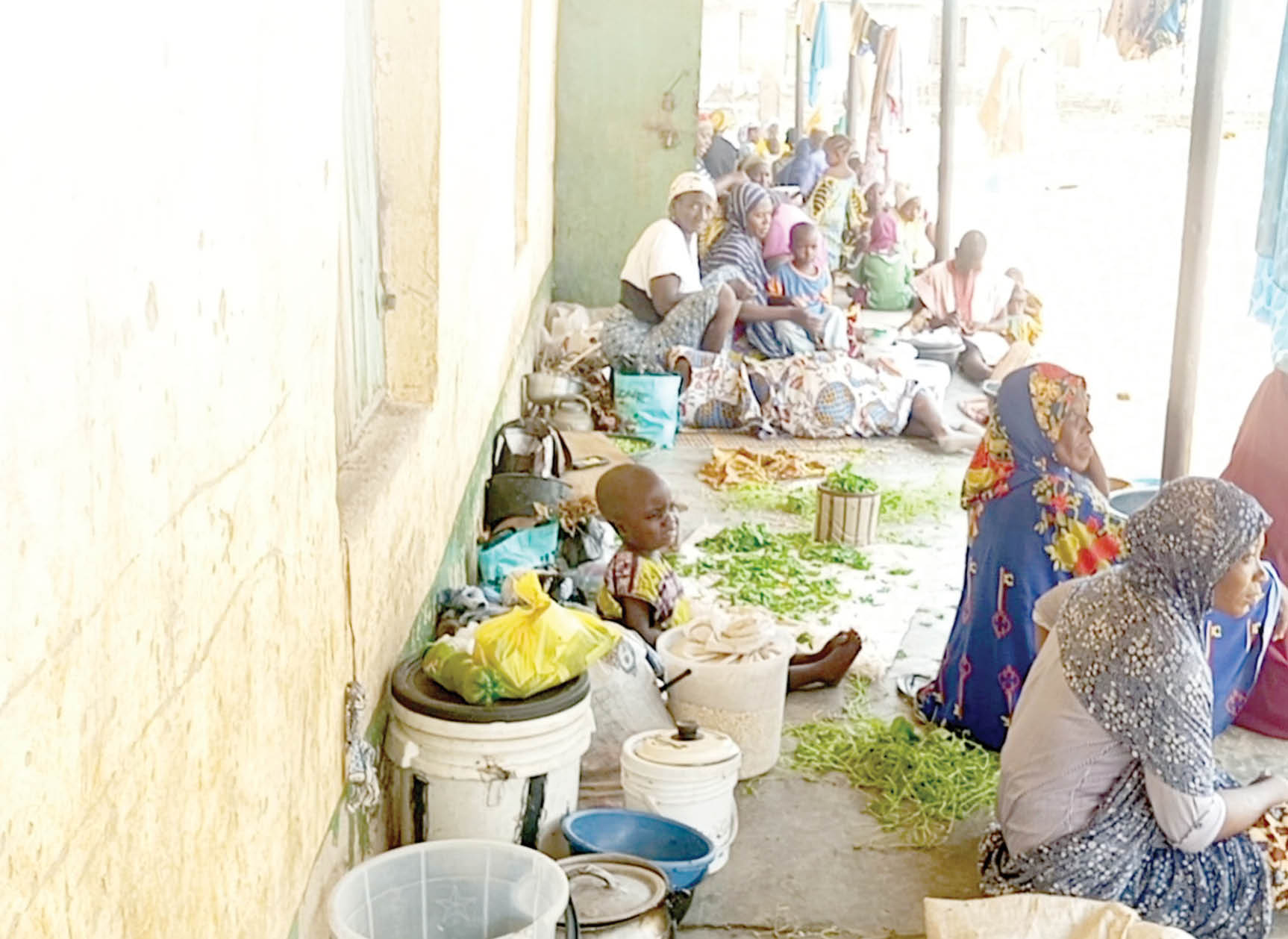 idps at kuta camp, shiroro lga of niger state. (inset) children taking garri at the camp